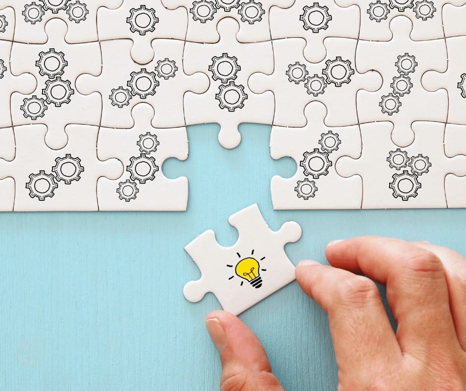 lightbulb idea puzzle piece fitting hand